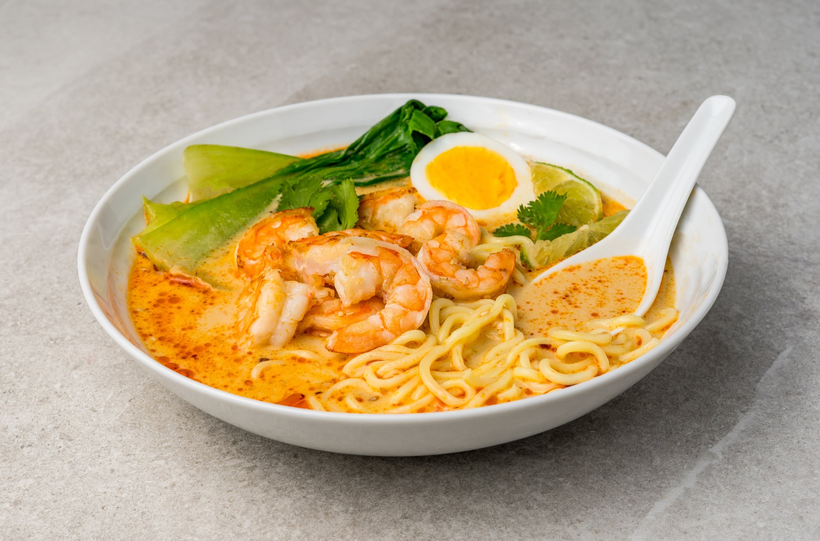 Coconut lime shrimp ramen with soft-boiled egg and cilantro
