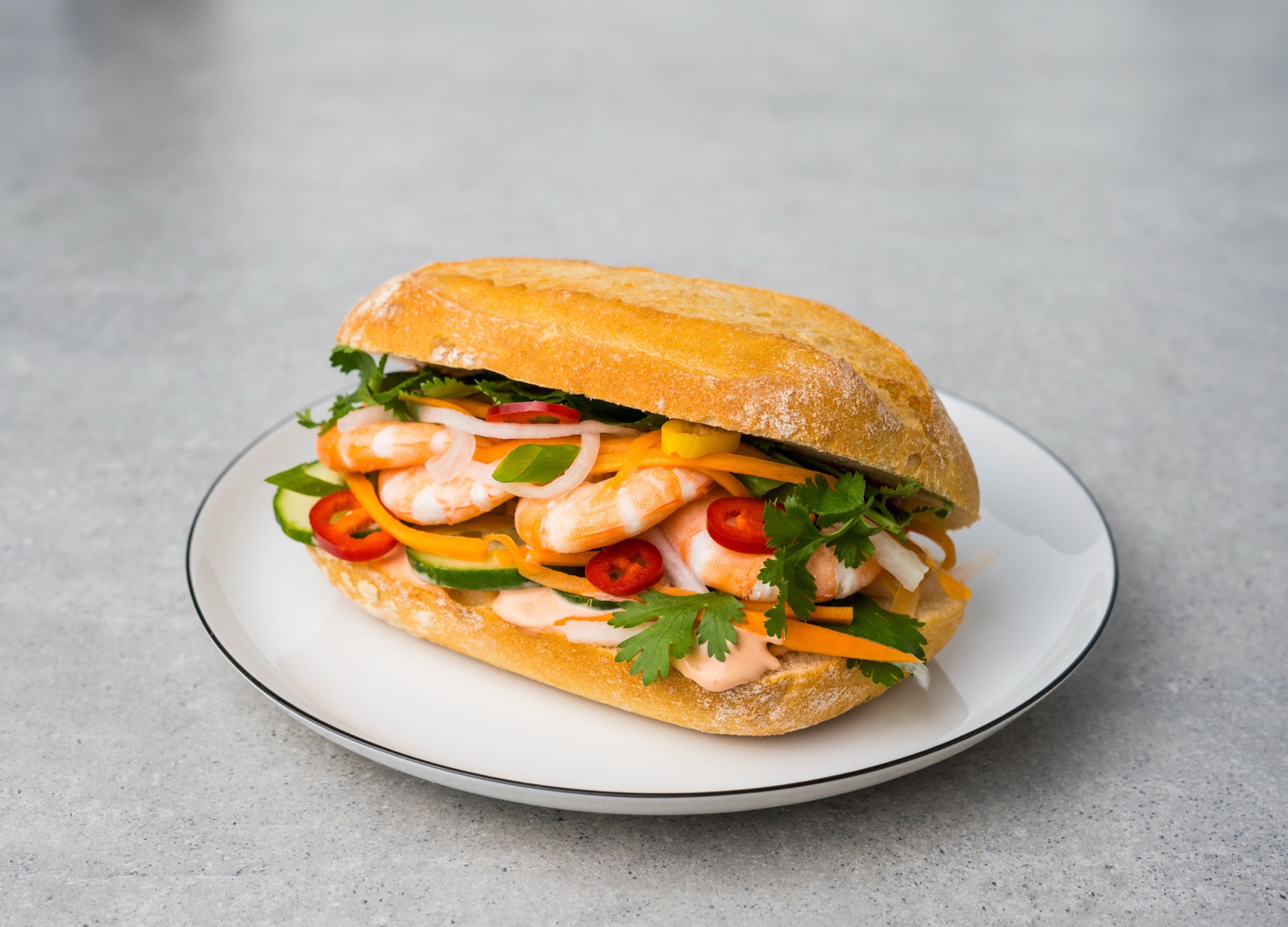 Bánh mì baguette filled with shrimp, pickled vegetables and cilantro