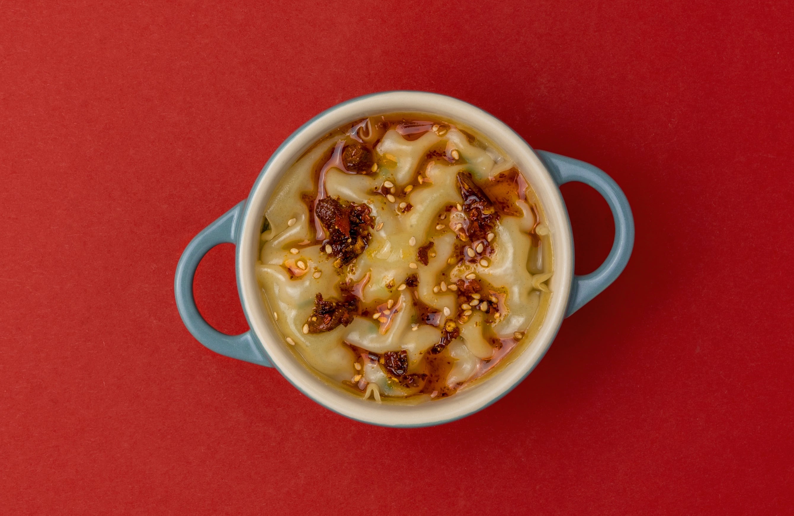 Steamed soup dumpling lasagna with sesame and crispy chili oil