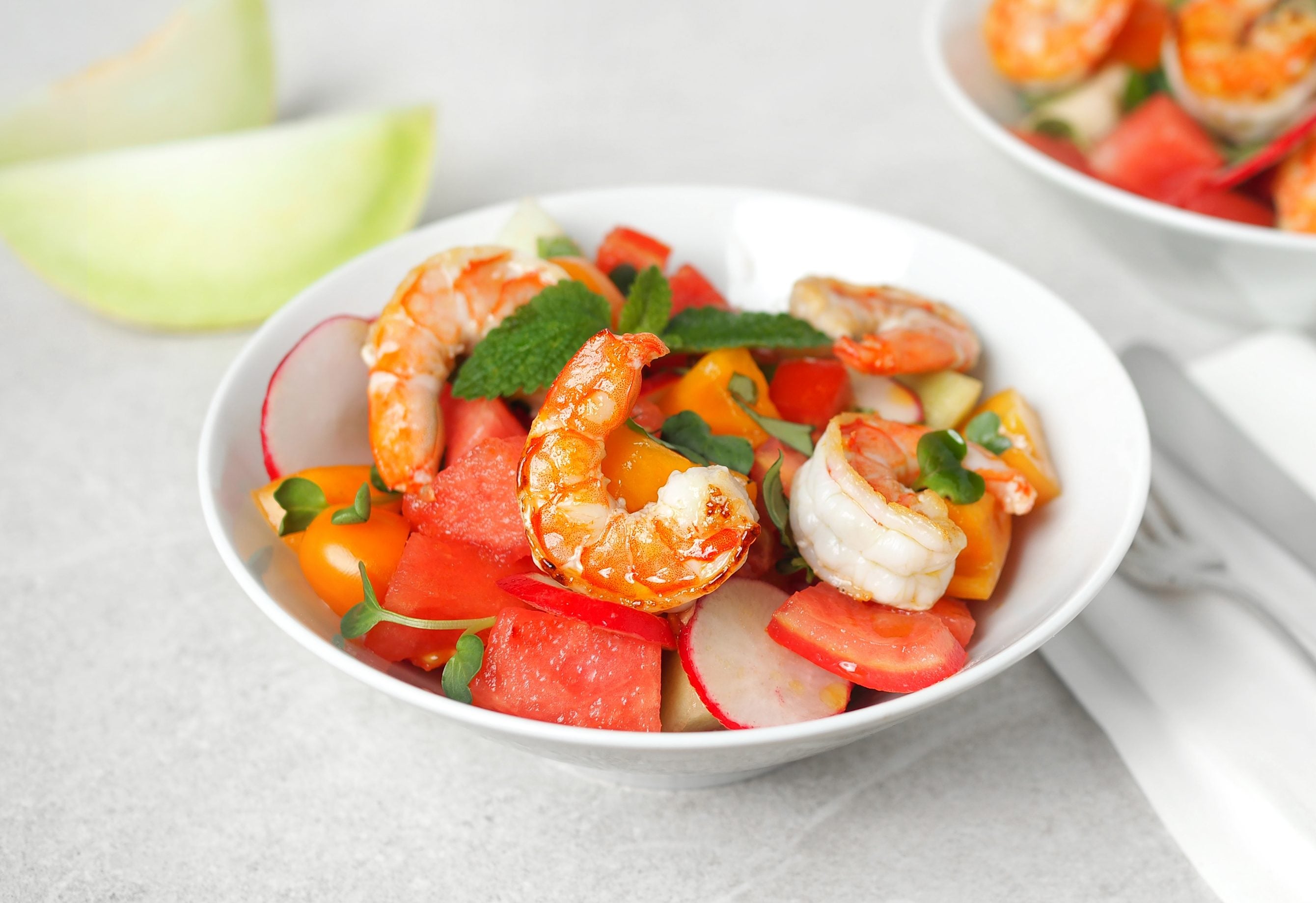 Bavarian shrimp on a watermelon and honeydew salad with radishes and mint