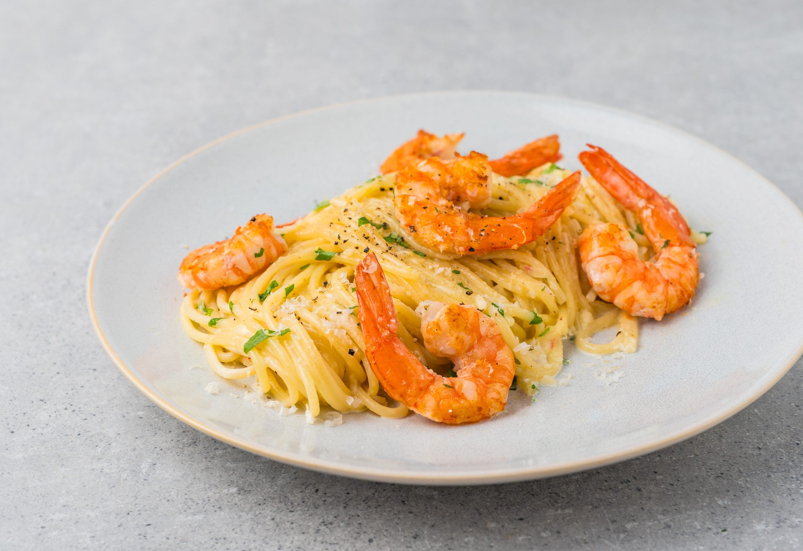 Creamy spaghetti with seared Bavarian shrimp, Parmesan and parsley on a plate