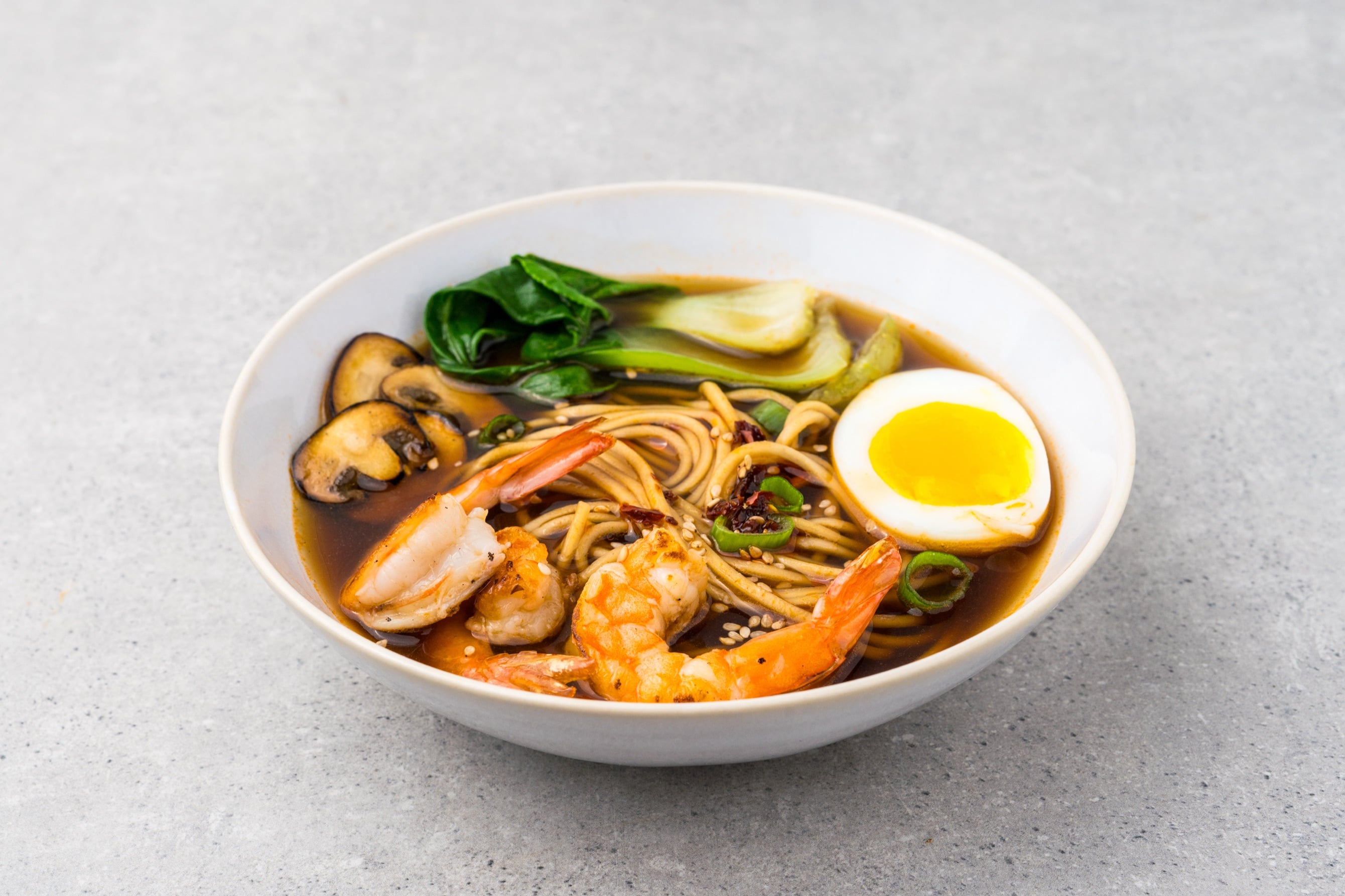 Bavarian shrimp Asian soup served ramen-style with egg and pak choi