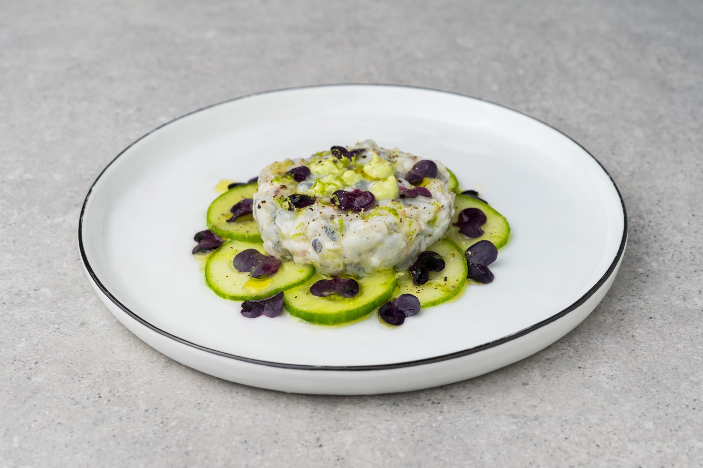 Bavarian shrimp tartare on a bed of cucumber slices with cress