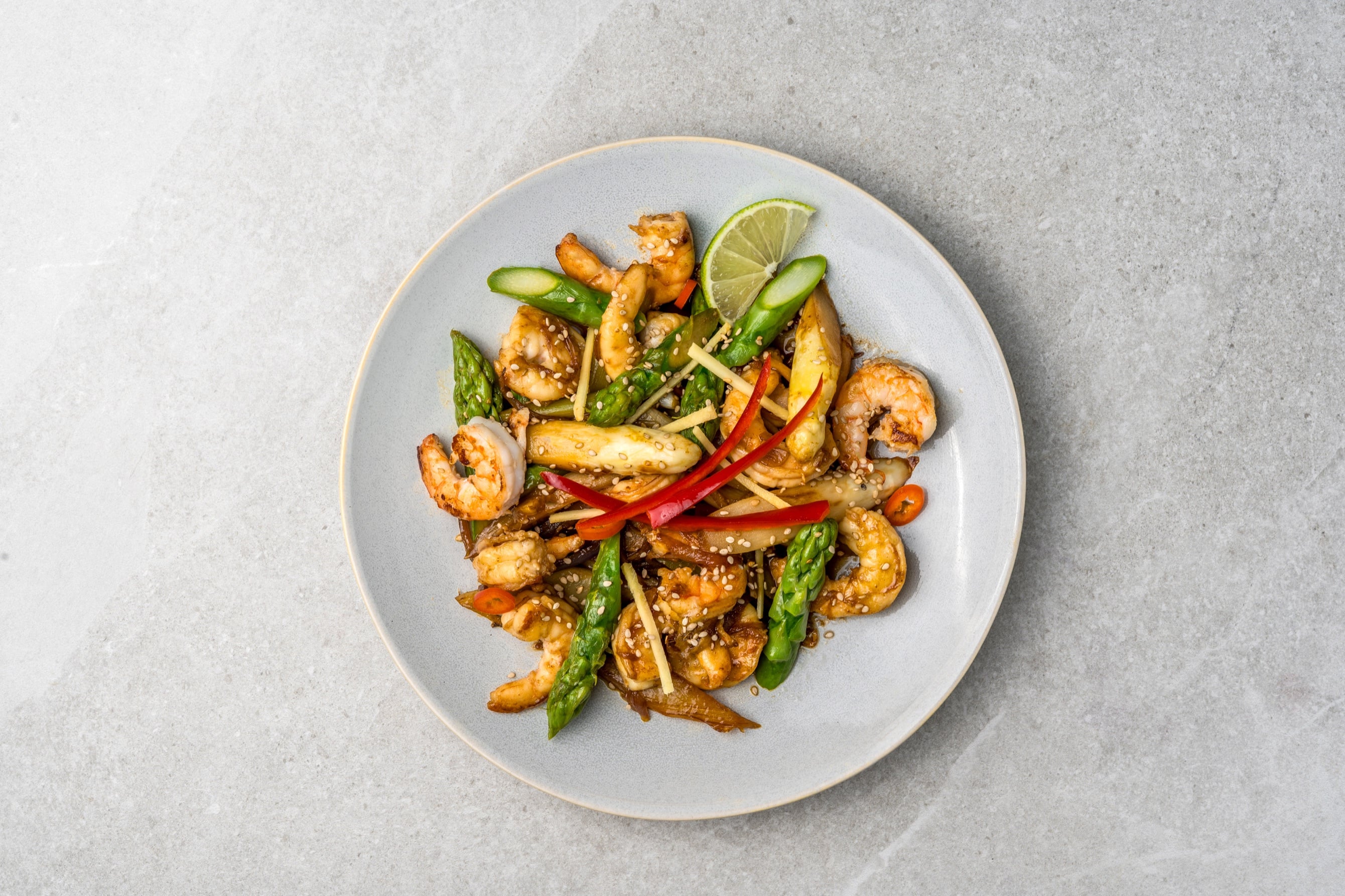 Wok-fried white and green asparagus with shrimp, chili and sesame